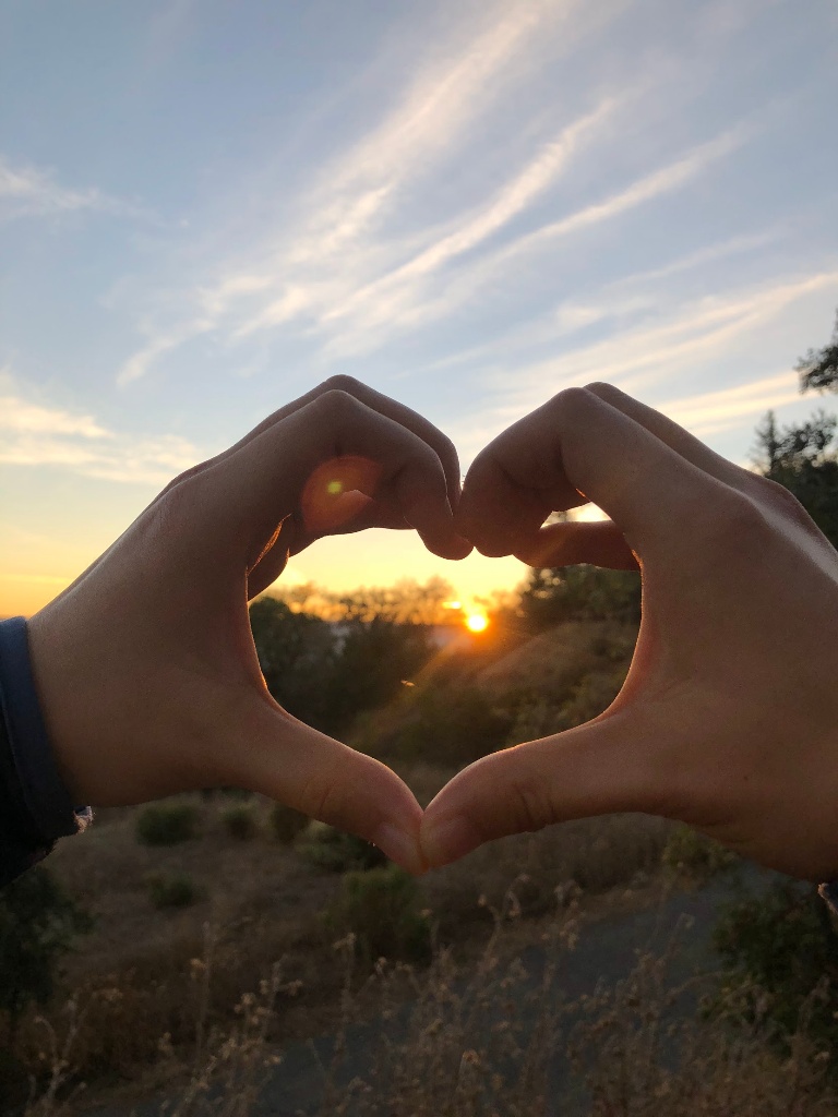 Heart hands at sunset on a hike with old friends, Meng Chen