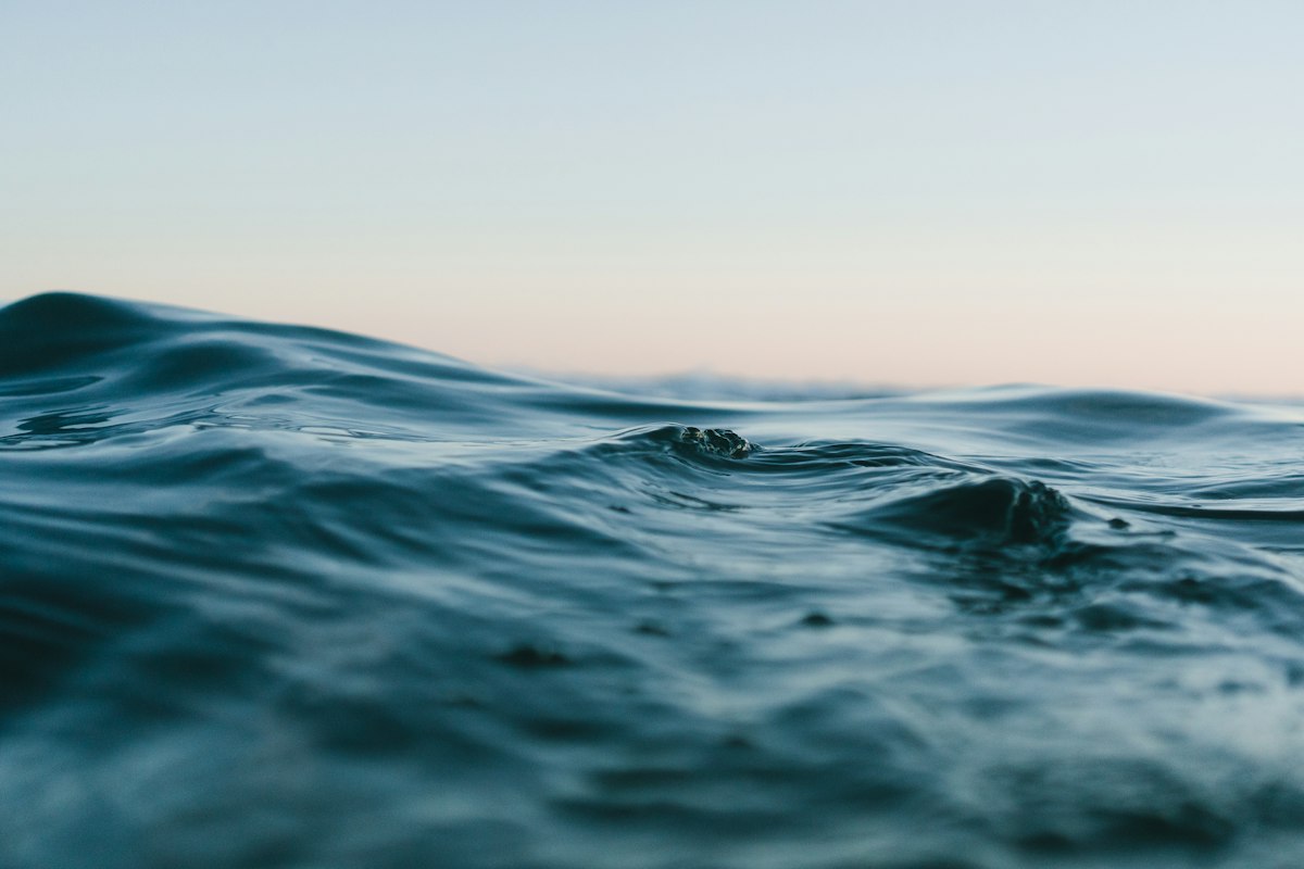 Calm soft blue water ripples with gentle natural light